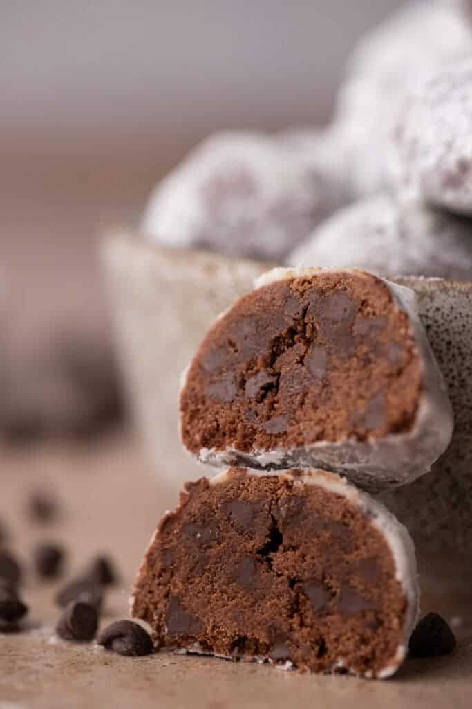 Two chocolate cookies stacked to show their soft 