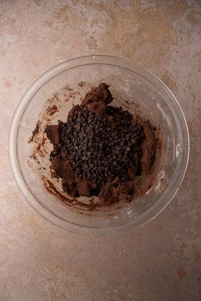 Finished chocolate cookie dough in a glass bowl.