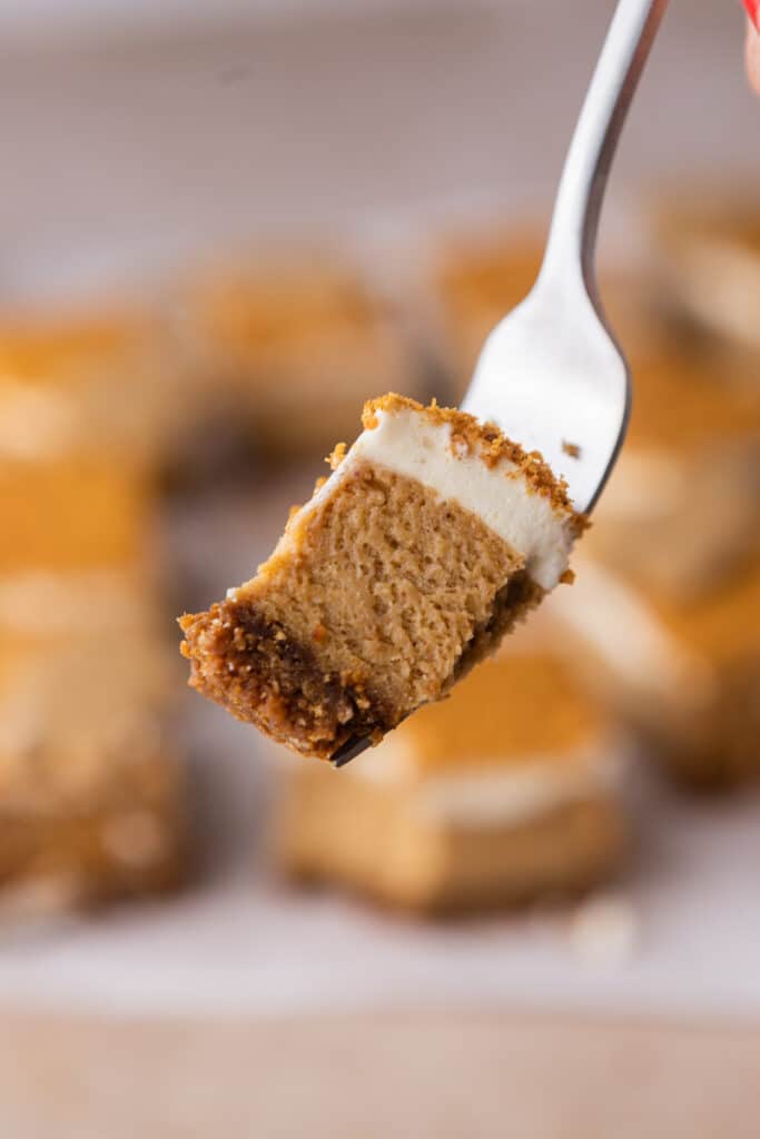 piece of gingerbread cheesecake bars on a fork