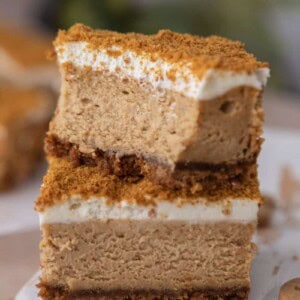 two gingerbread cheesecake bars stacked on top of each other