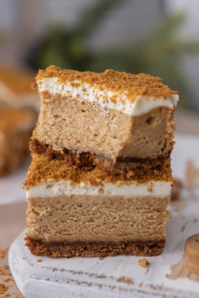 two gingerbread cheesecake bars stacked on top of each other