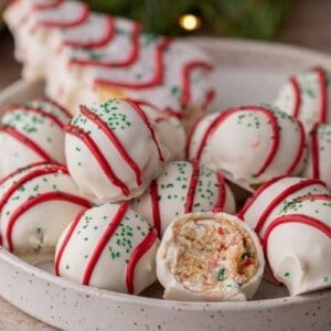 multiple little debbie christmas tree cakes truffles in a bowl with one has a bite taken out