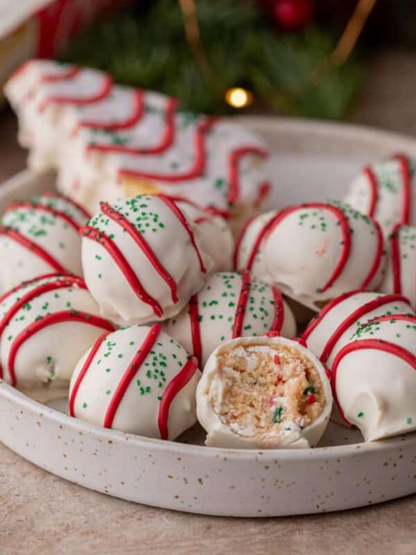 multiple little debbie christmas tree cakes truffles in a bowl with one has a bite taken out
