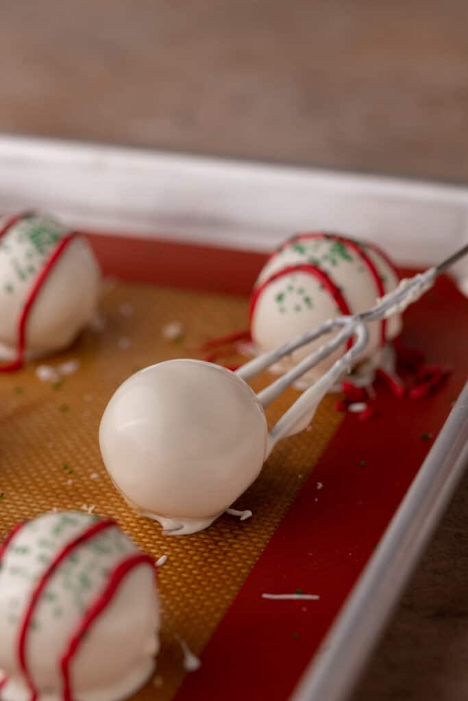 dipped ball being put on a baking sheet
