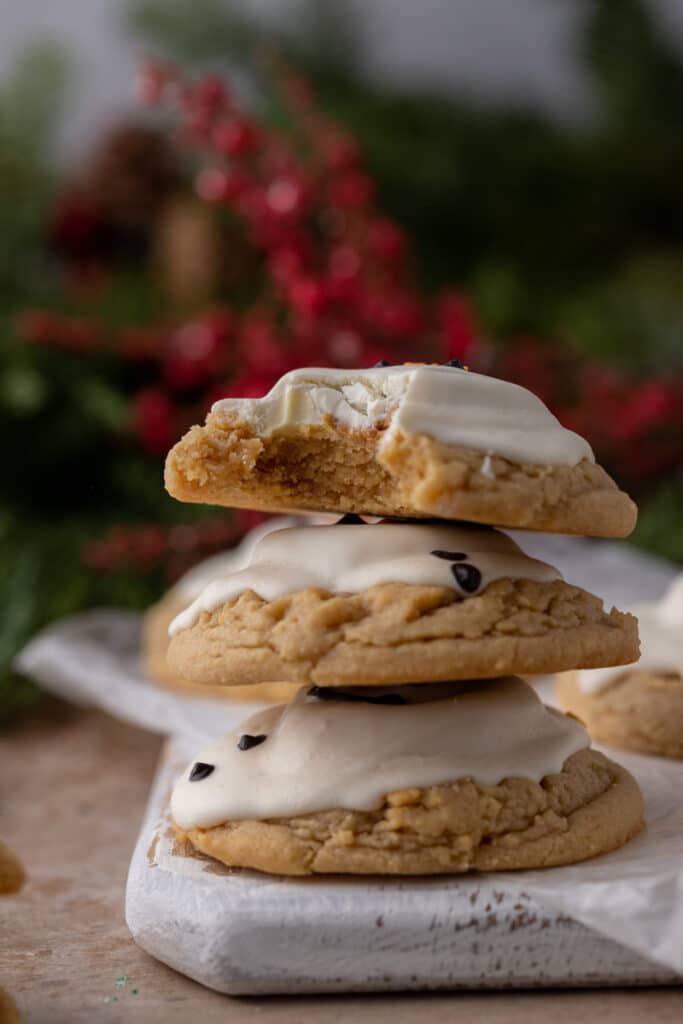 three melted snowman peanut butter cookies stacked on top of one another