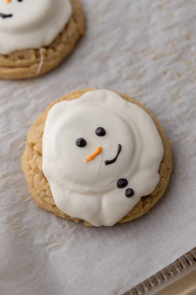 a fully baked and decorated melted snowman peanut butter cookie