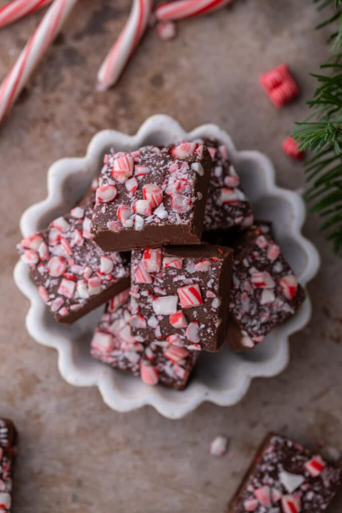 overhead shot of the multiple squares from the peppermint fudge recipe stacked in a bowl