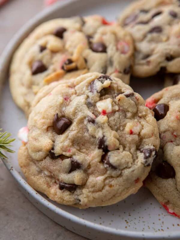 close up of a peppermint chocolate chip cookie with others behind it on a plate