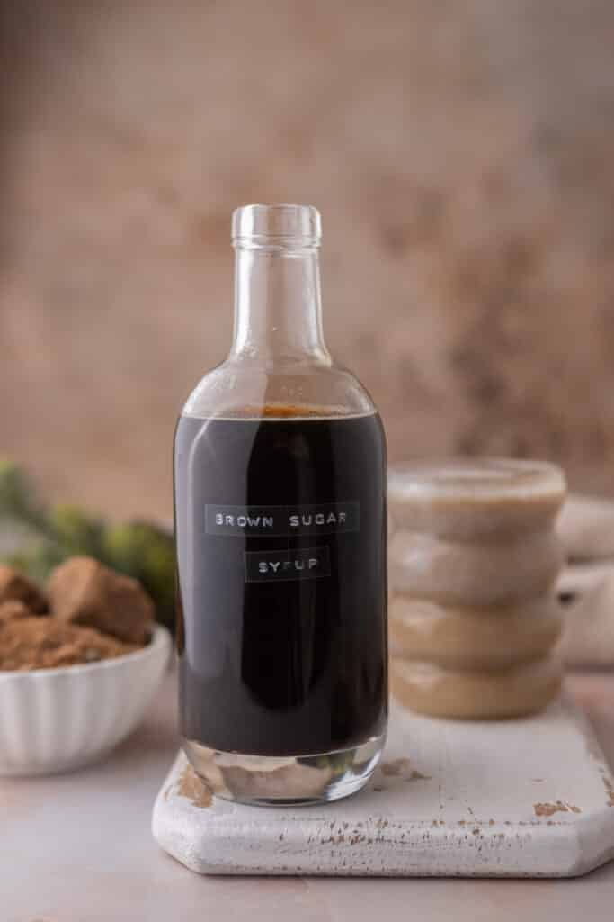 starbucks brown sugar syrup recipe sitting in front of a cup of coffee