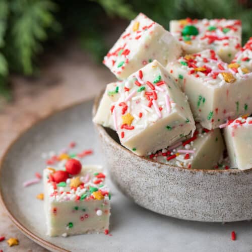 sugar cookie fudge squares in a bowl with one square on the side