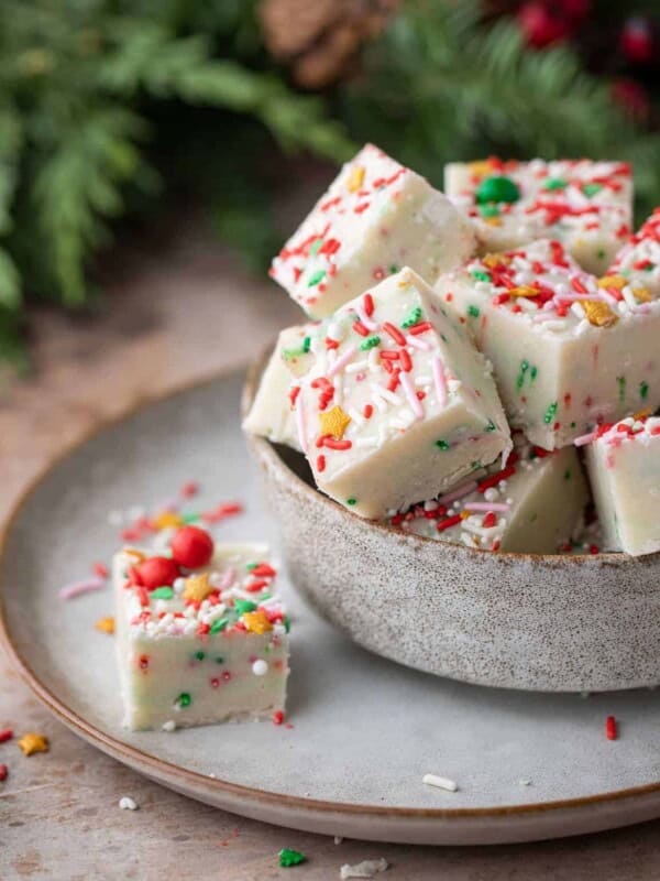 sugar cookie fudge squares in a bowl with one square on the side