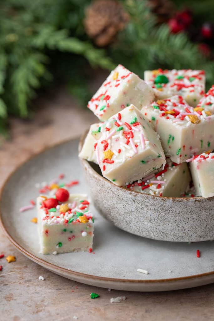 sugar cookie fudge squares in a bowl with one square on the side