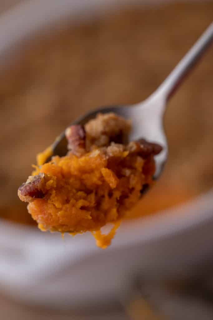 a spoonful of sweet potato casserole with pecans