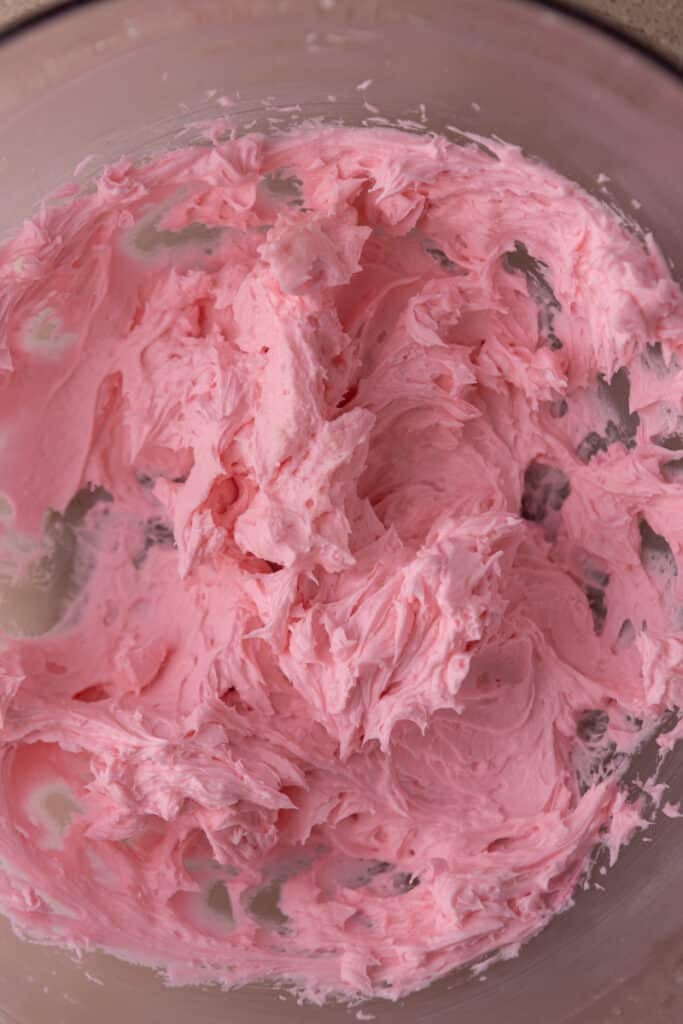 Pink frosting in a bowl