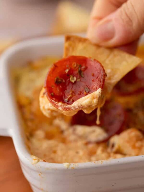 a scoop of the cottage cheese pizza bowl dip on a chip