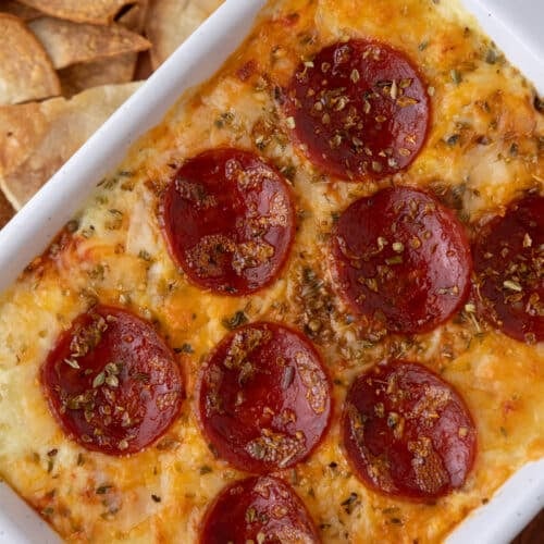 overhead shot of a diagonal plate of fully cooked cottage cheese pizza bowl dip