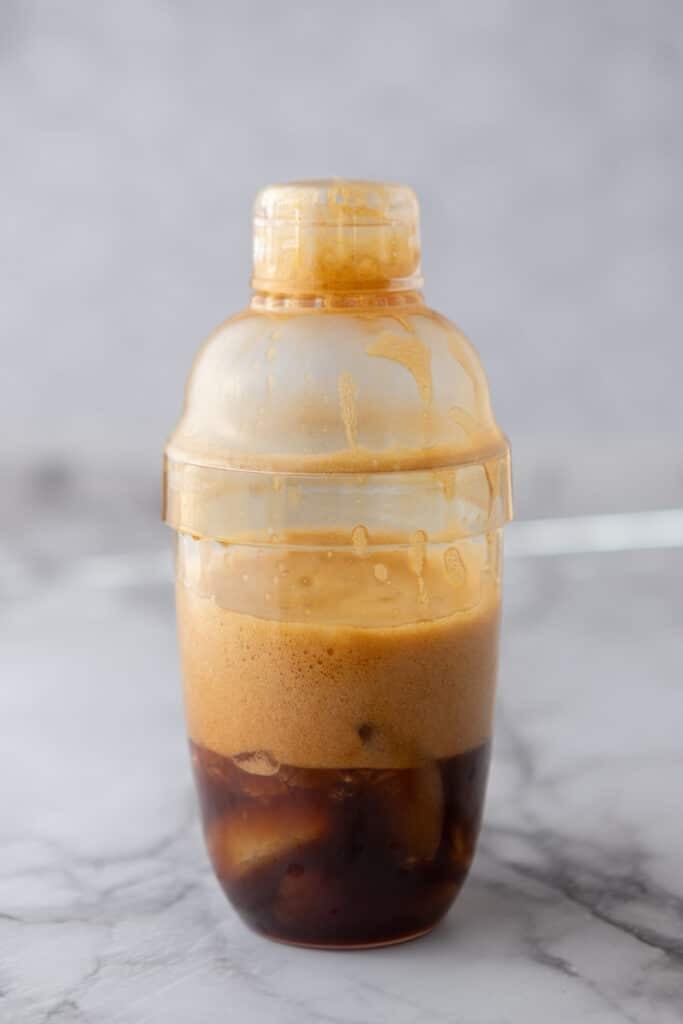coffee that has been shaken with ice in a cocktail shaker