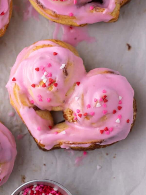 close up of a valentine's day heart shaped cinnamon rolls
