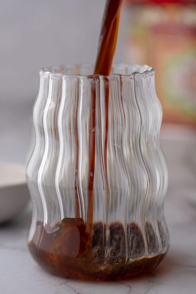 coffee being poured into a glass