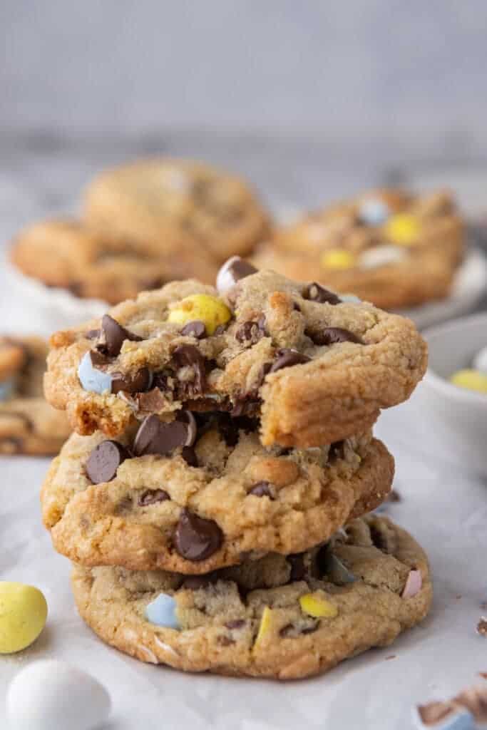 Brown butter Cadbury mini egg cookies stacked on parchment paper one of the best easy easter dessert recipes