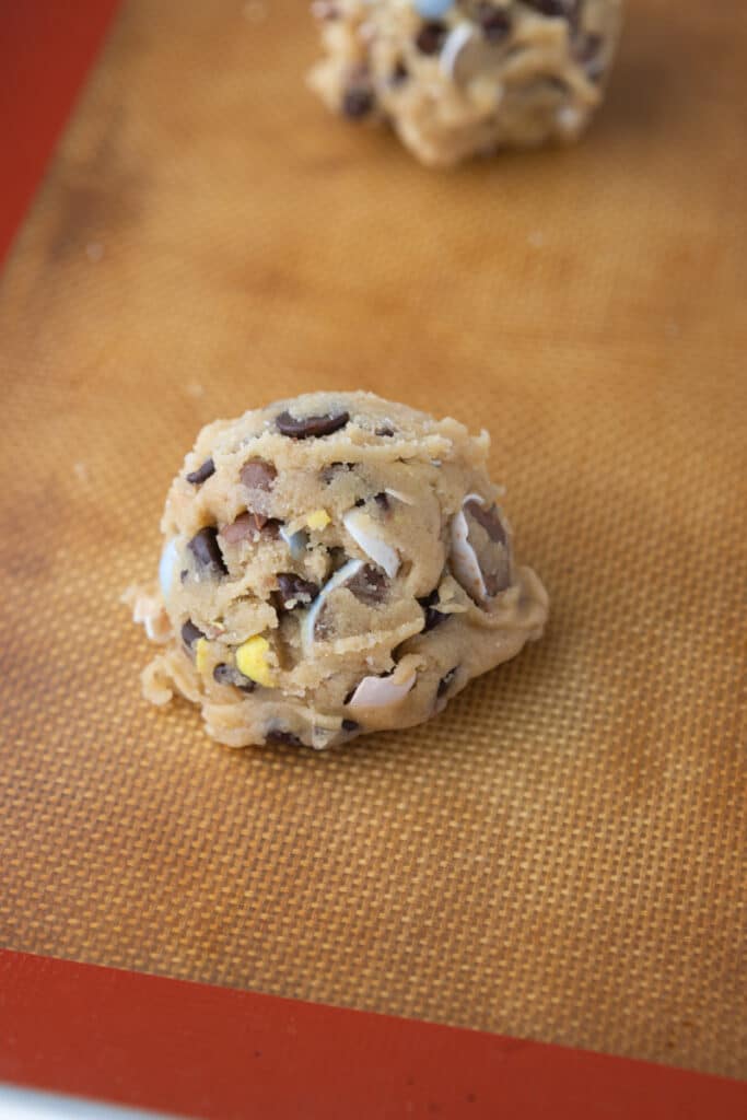 ball of raw cookie dough on a baking sheet