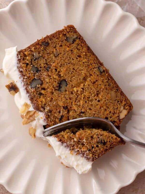 a slice of the carrot cake loaf cake recipe getting a piece taken out