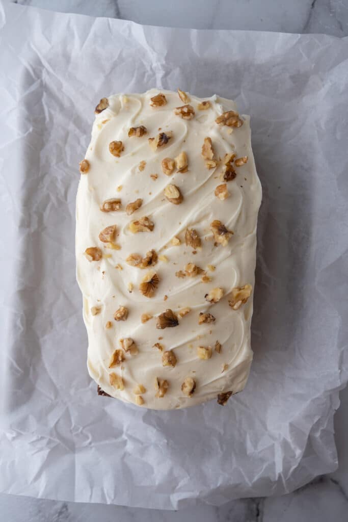 carrot cake loaf cake recipe with cream cheese frosting on it