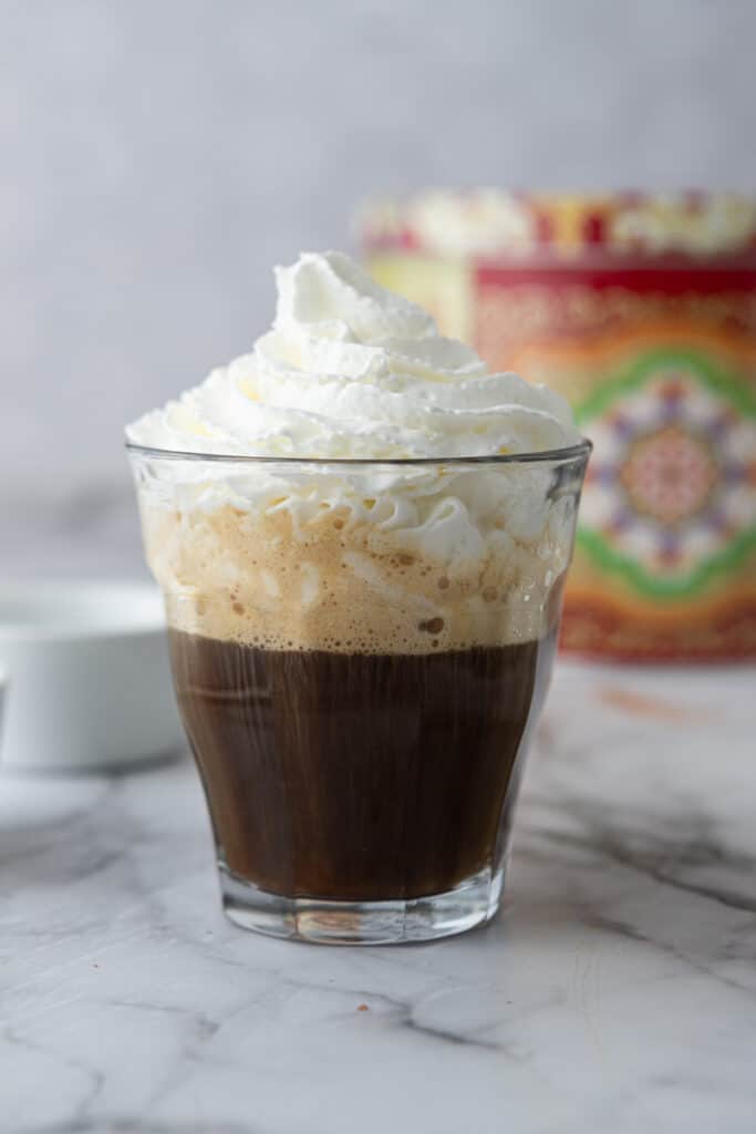 espresso and whipped cream in a glass cup