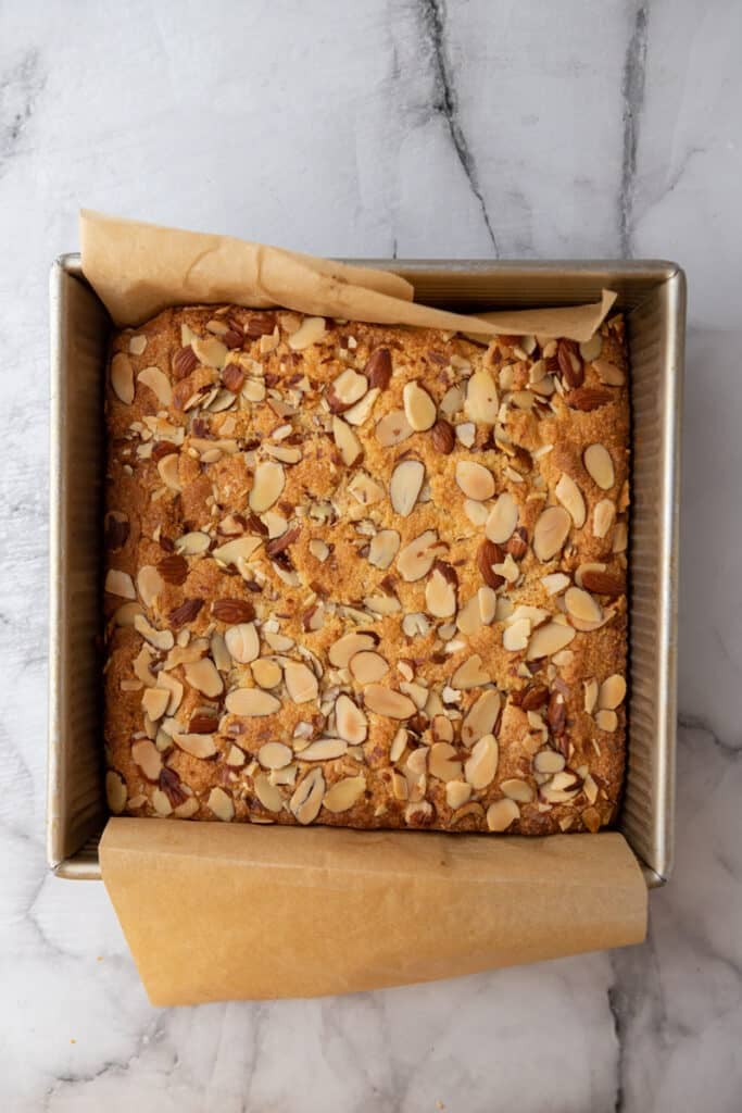 fully baked almond croissant blondies in a pan