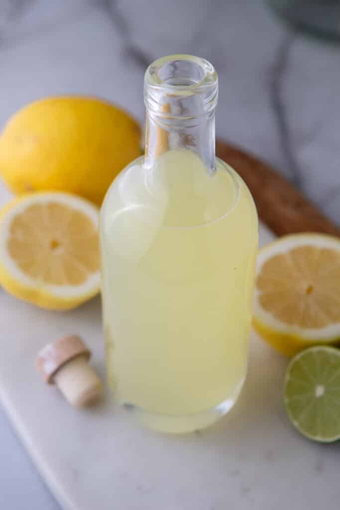overhead shot of the how to make homemade lemon sour mix in a bottle