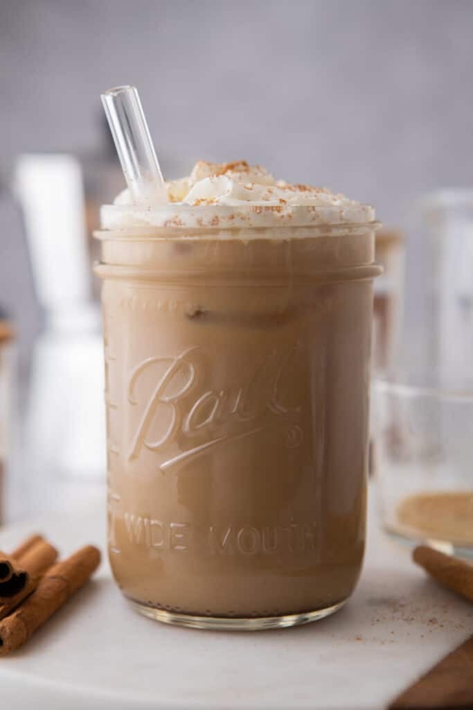 a maple latte in a glass with a straw