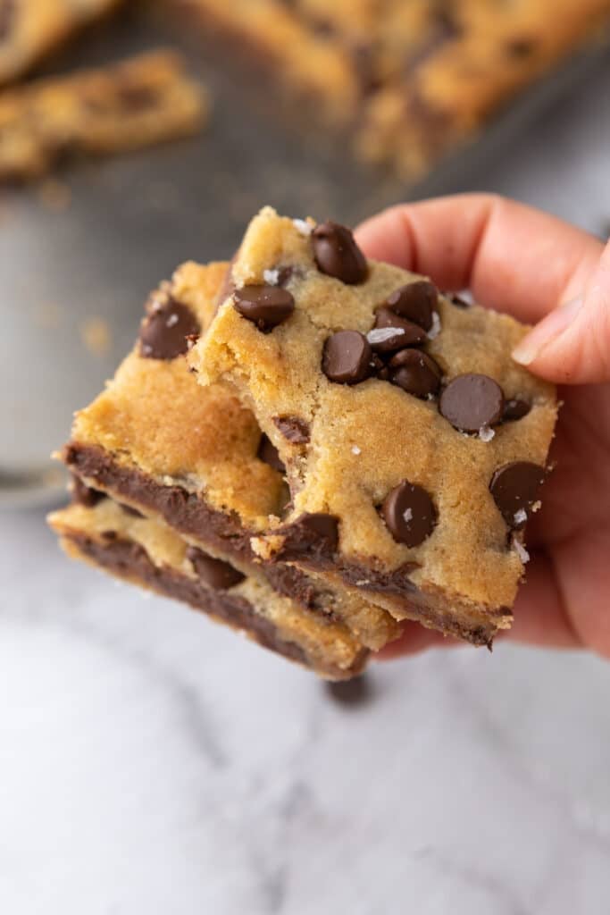 Hand holding chocolate chip cookie bars