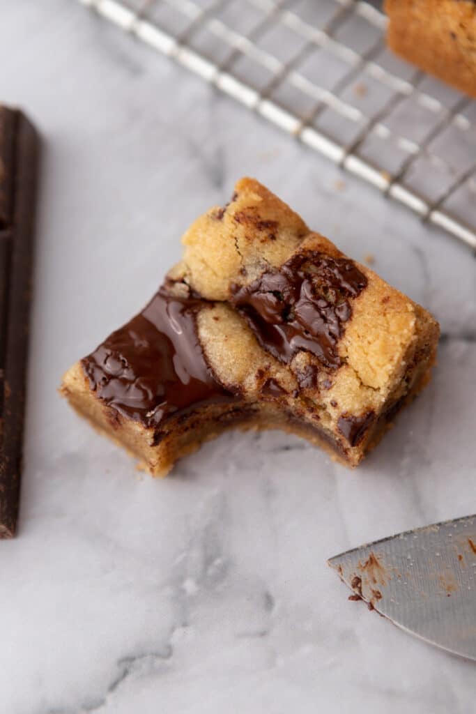 a square of cookie bar with a bite taken out