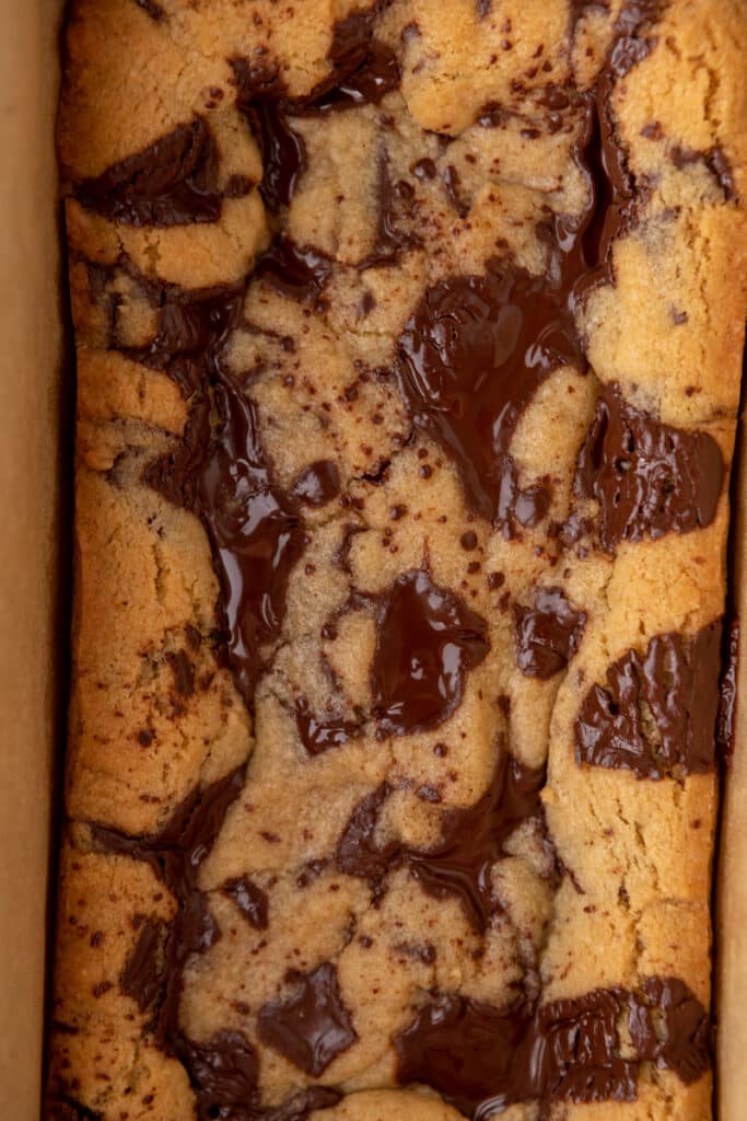close up of the fully baked small batch chocolate chip cookie bars in a pan