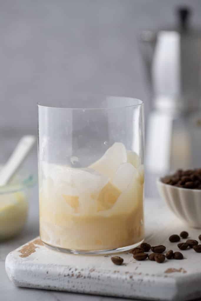 sweetened condensed milk in a glass with ice