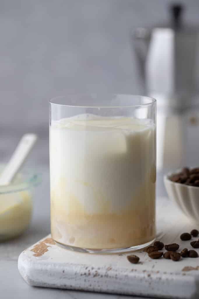 milk and sweetened condensed milk in a glass with ice