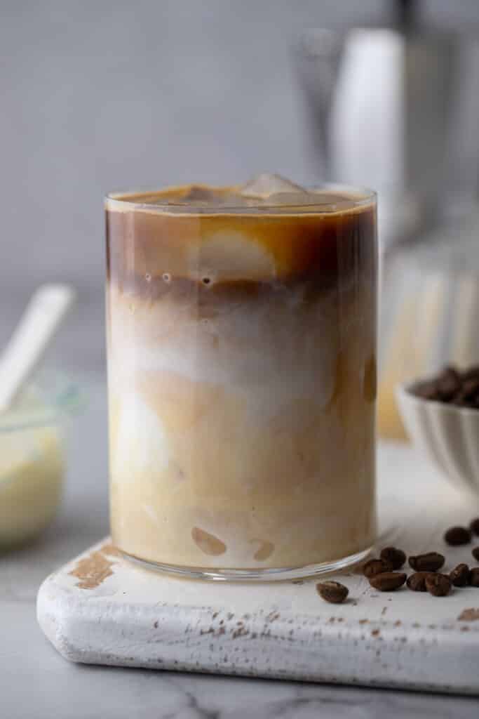 espresso, milk and sweetened condensed milk in a glass with ice