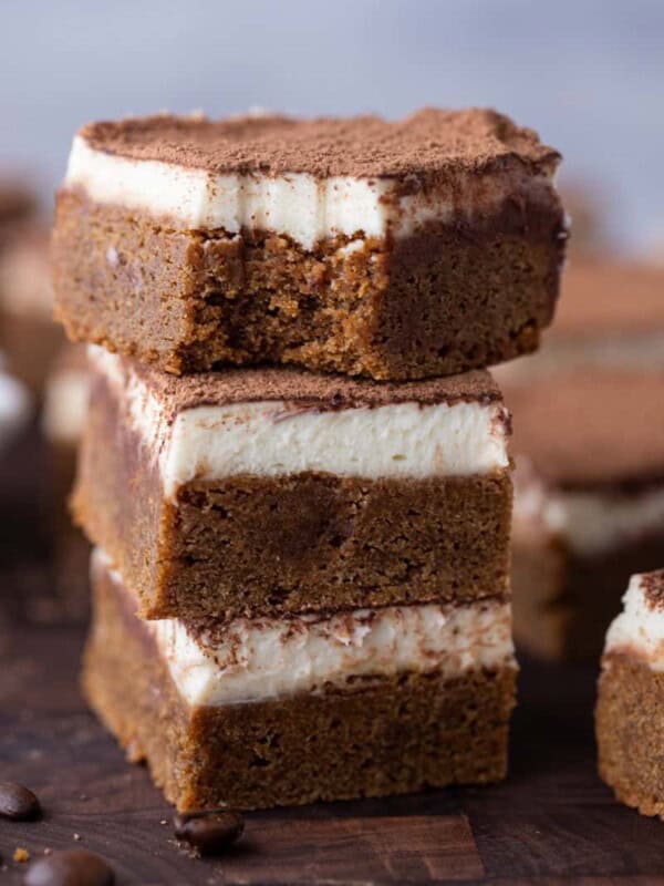 three tiramisu blondies recipe squares stacked on top of each other
