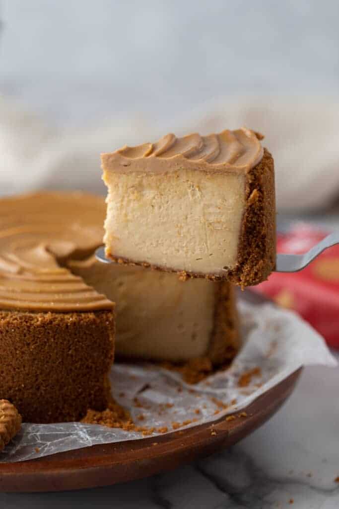 a slice of the 6-inch biscoff cheesecake recipe being held up by a serving spatula