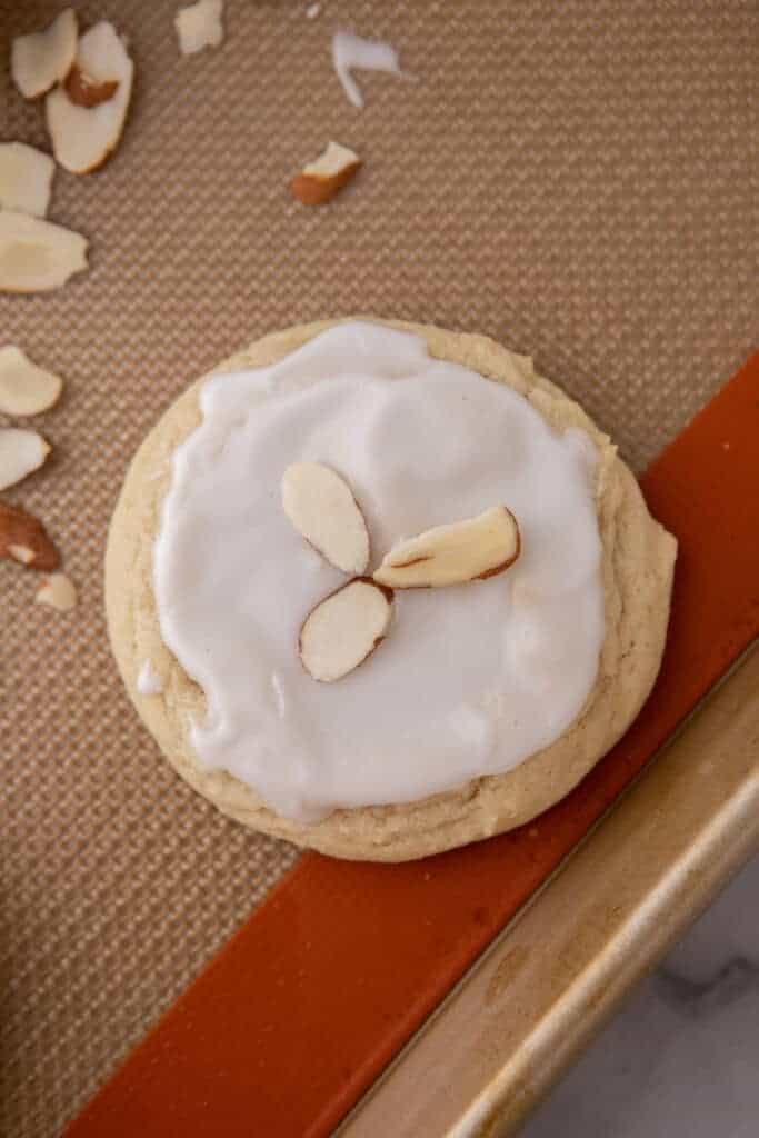 Frosted soft almond sugar cookie on a baking sheet