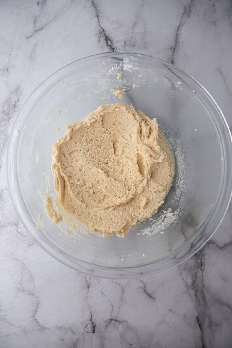 Soft almond sugar cookie dough in a mixing bowl.