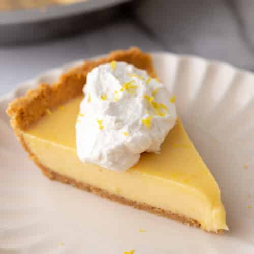 a slice of the lemon pie with graham cracker crust on a plate