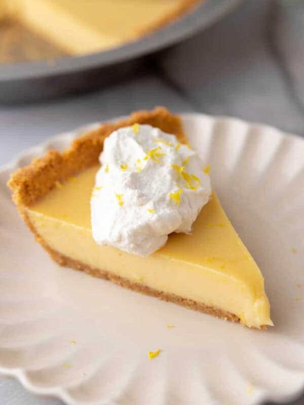 a slice of the lemon pie with graham cracker crust on a plate