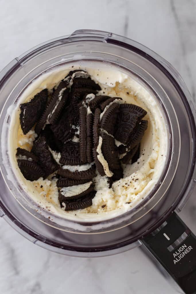 oreo cookies added to the blended ingredients in a cup