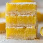 three squares from the easy lemon bars recipe stacked on top of each other.