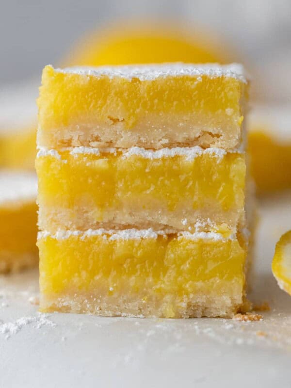 three squares from the easy lemon bars recipe stacked on top of each other.