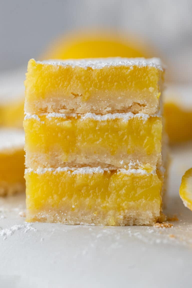 three squares from the easy lemon bars recipe stacked on top of each other.