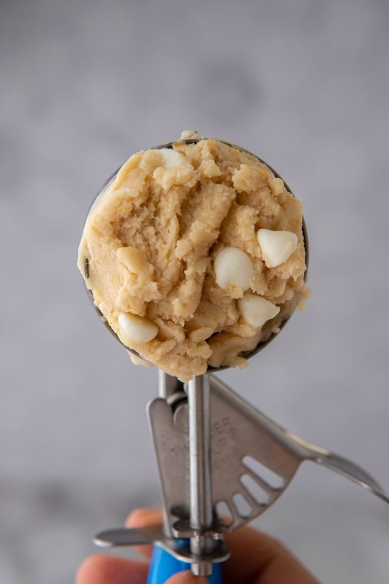 A cookie scoop filled with edible lemon cookie dough.