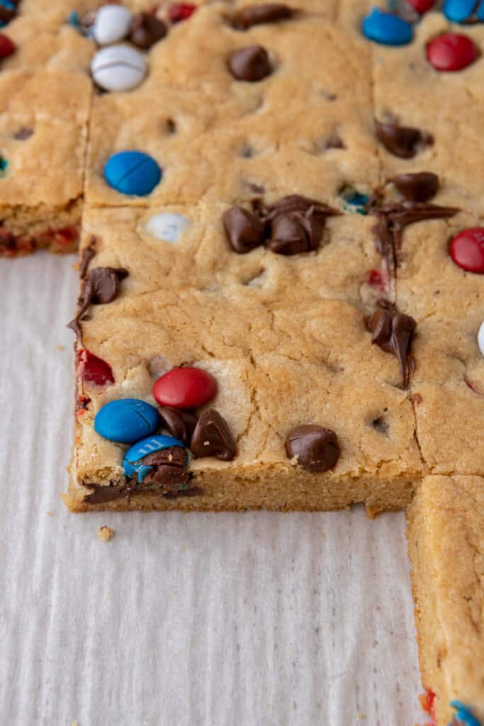 Sliced patriotic sheet pan red white and blue M&M's cookie bars