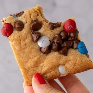 Hand holding patriotic sheet pan red white and blue M&M's cookie bars